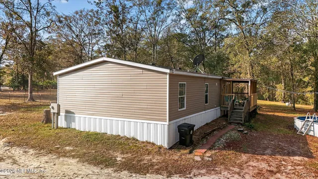 a view of a house with a yard and sitting area