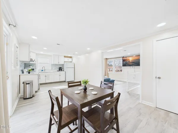 a kitchen with white cabinets and white appliances