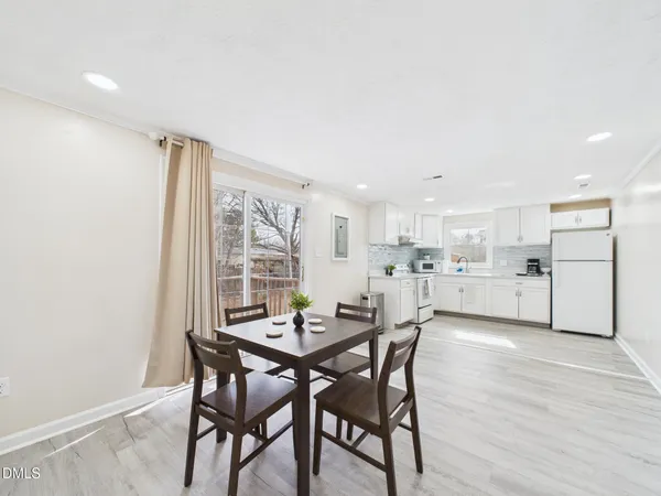 a kitchen with white cabinets white appliances and white appliances