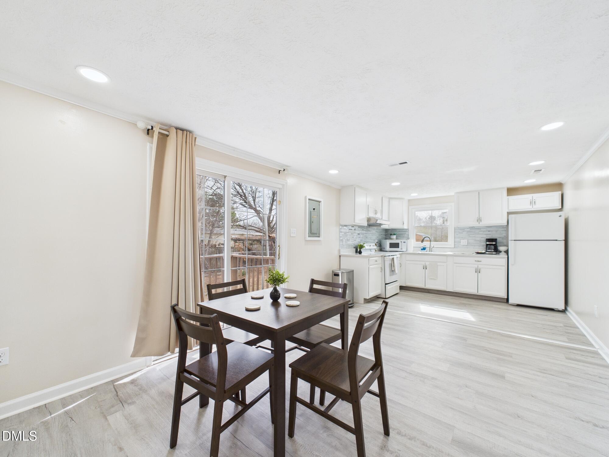 72 Edgemont Avenue Roxboro, NC 27573 - Photo 10 of 45 a view of a dining room with furniture and wooden floor