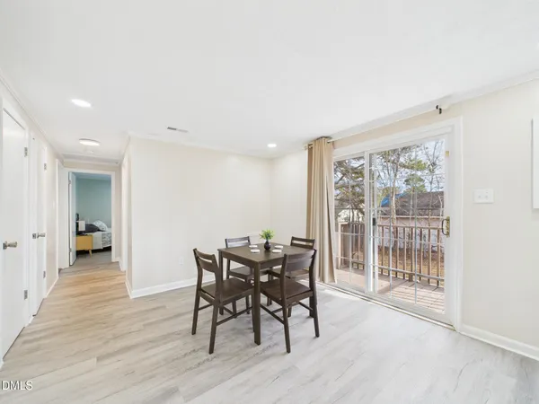 a view of a dining room and kitchen with a table chairs a sink and dishwasher