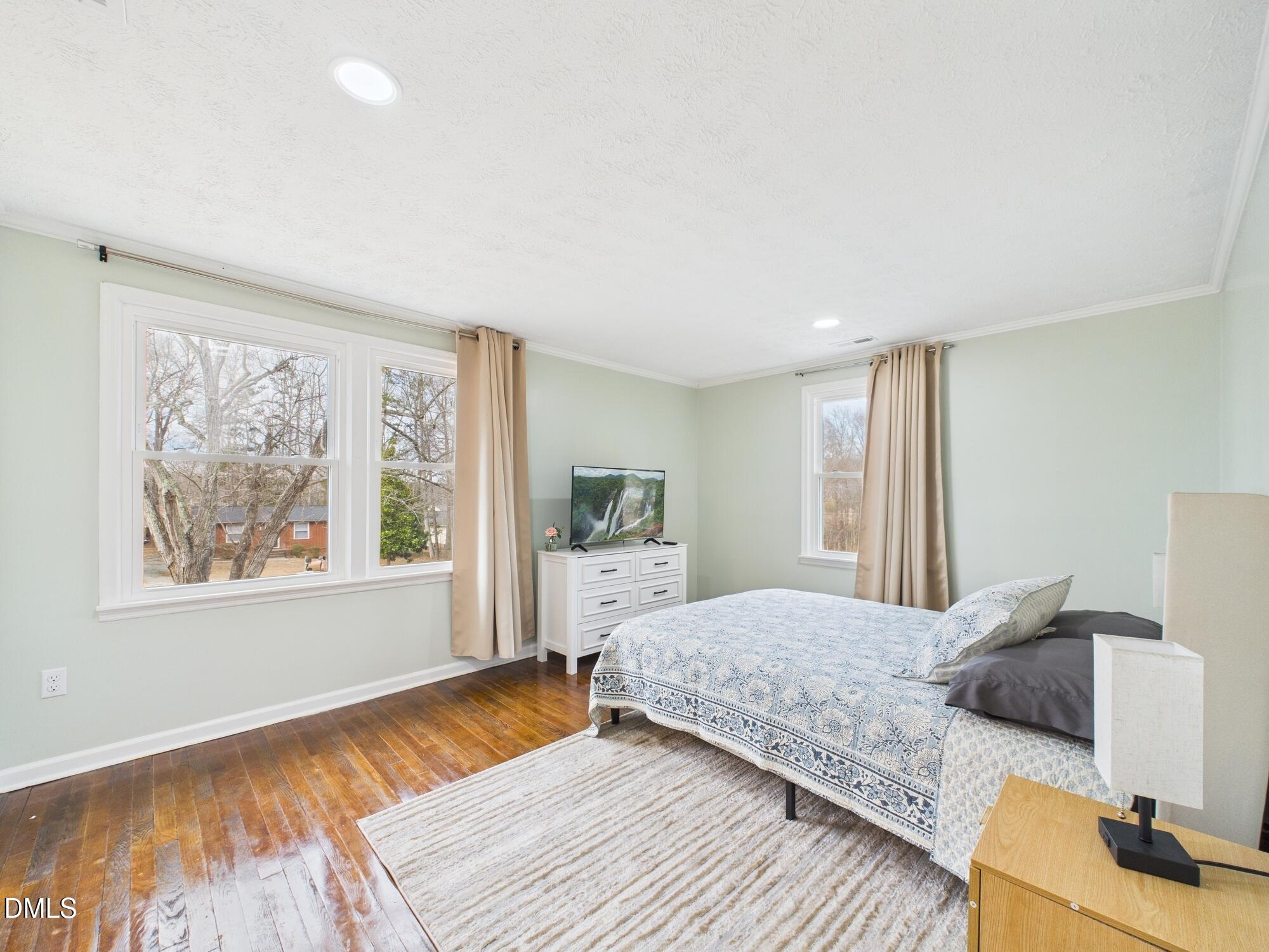 72 Edgemont Avenue Roxboro, NC 27573 - Photo 13 of 45 a bedroom with a bed and wooden floor