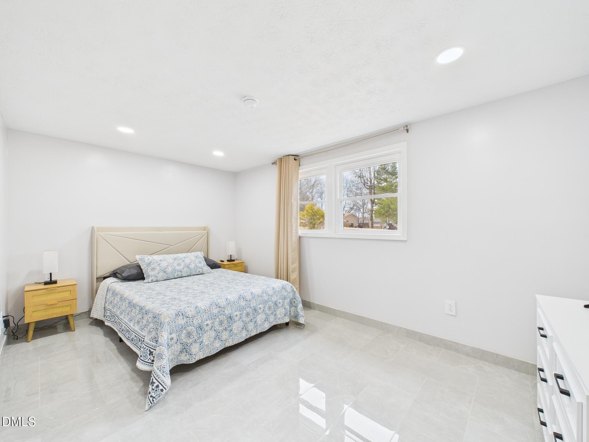 72 Edgemont Avenue Roxboro, NC 27573 - Photo 22 of 45 a bedroom with a bed and painting on the wall