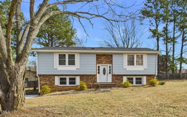 a house that has a tree in front of it