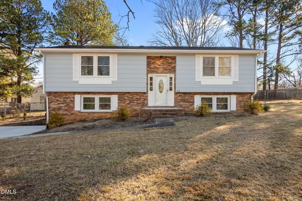 a view of a house with a large tree in front of a house