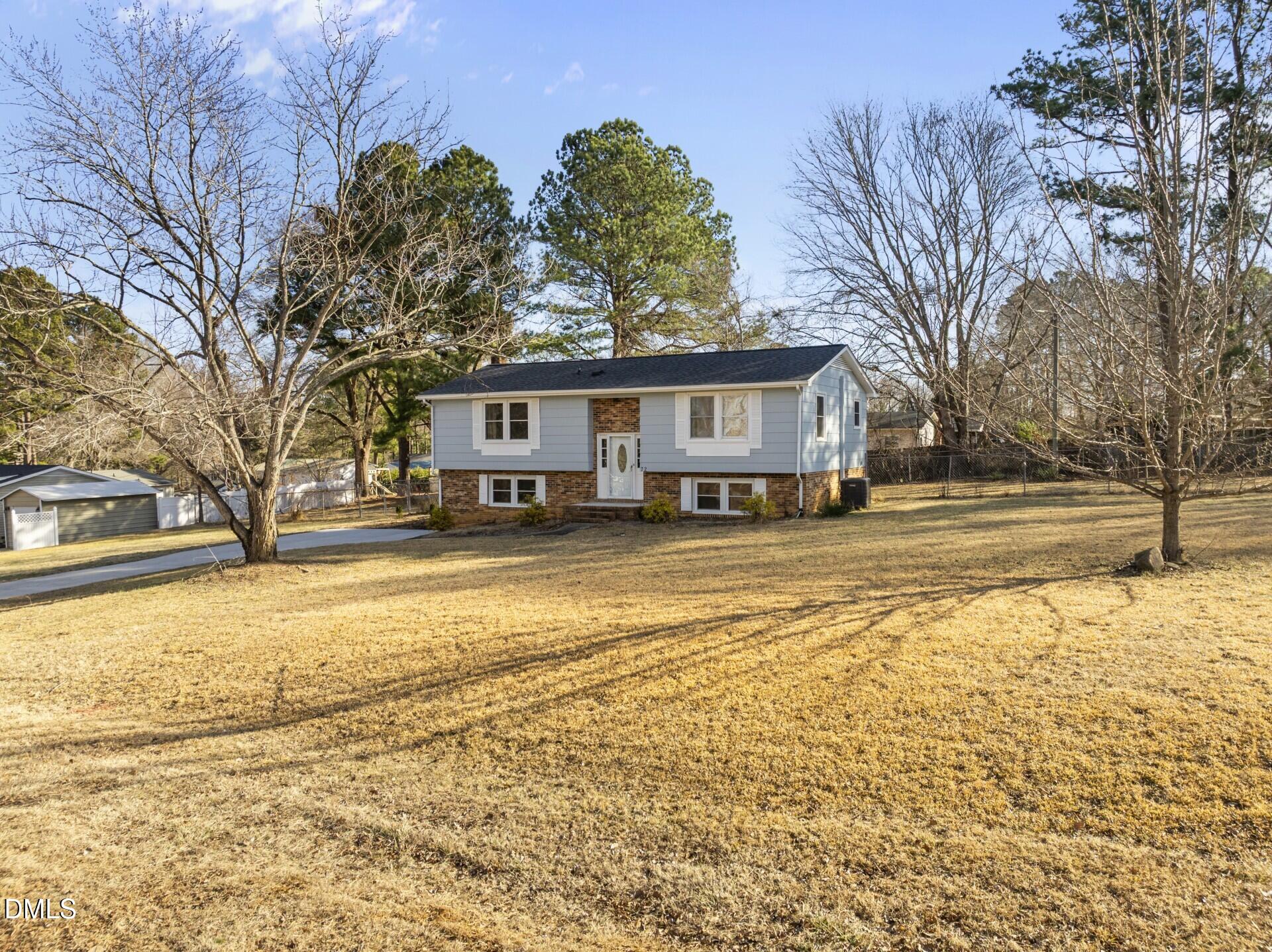 72 Edgemont Avenue Roxboro, NC 27573 - Photo 3 of 45 a view of a white house with a yard covered with snow