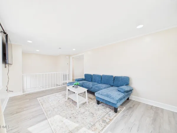 a view of a white house with a yard covered with snow