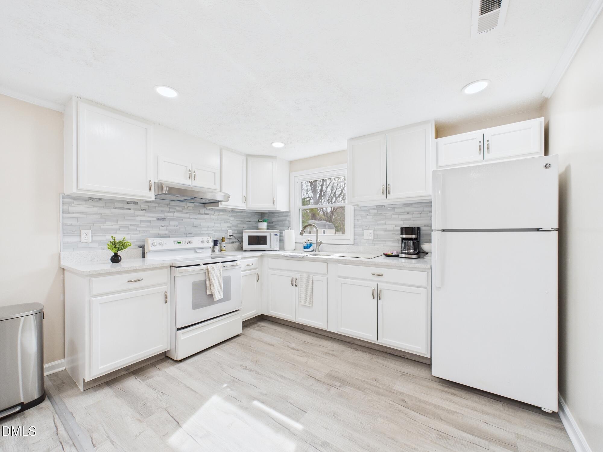 72 Edgemont Avenue Roxboro, NC 27573 - Photo 8 of 45 a kitchen with white cabinets white appliances and white appliances