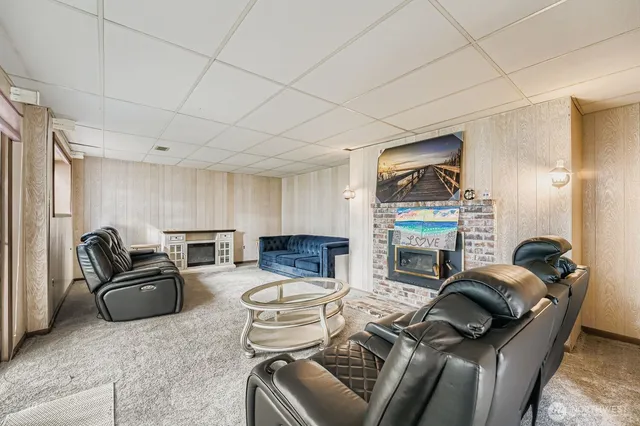 a living room with furniture a fireplace and a large window