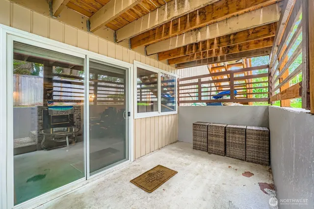 a view of a backyard with wooden fence and a bench