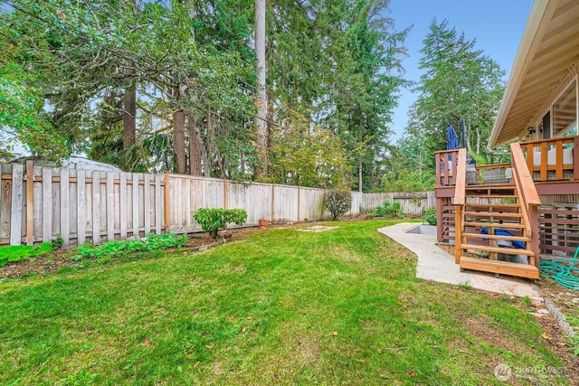 a view of a house with a yard and sitting area