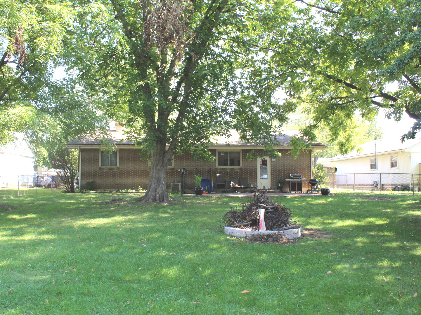414 Northgate Road Lindenhurst, IL 60046 - Photo 22 of 22 a view of a backyard with table and chairs and a large tree