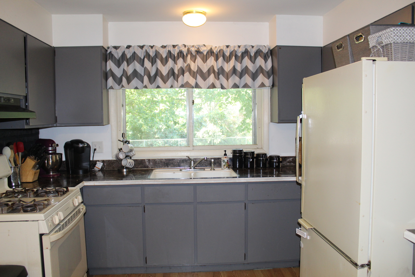 414 Northgate Road Lindenhurst, IL 60046 - Photo 9 of 22 a kitchen with a sink a refrigerator and window