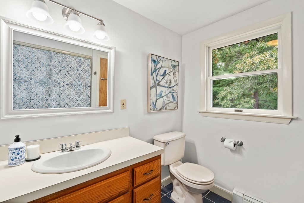 449 Potter Road Framingham, MA 01701 - Photo 13 of 25 a bathroom with a granite countertop sink mirror and a toilet