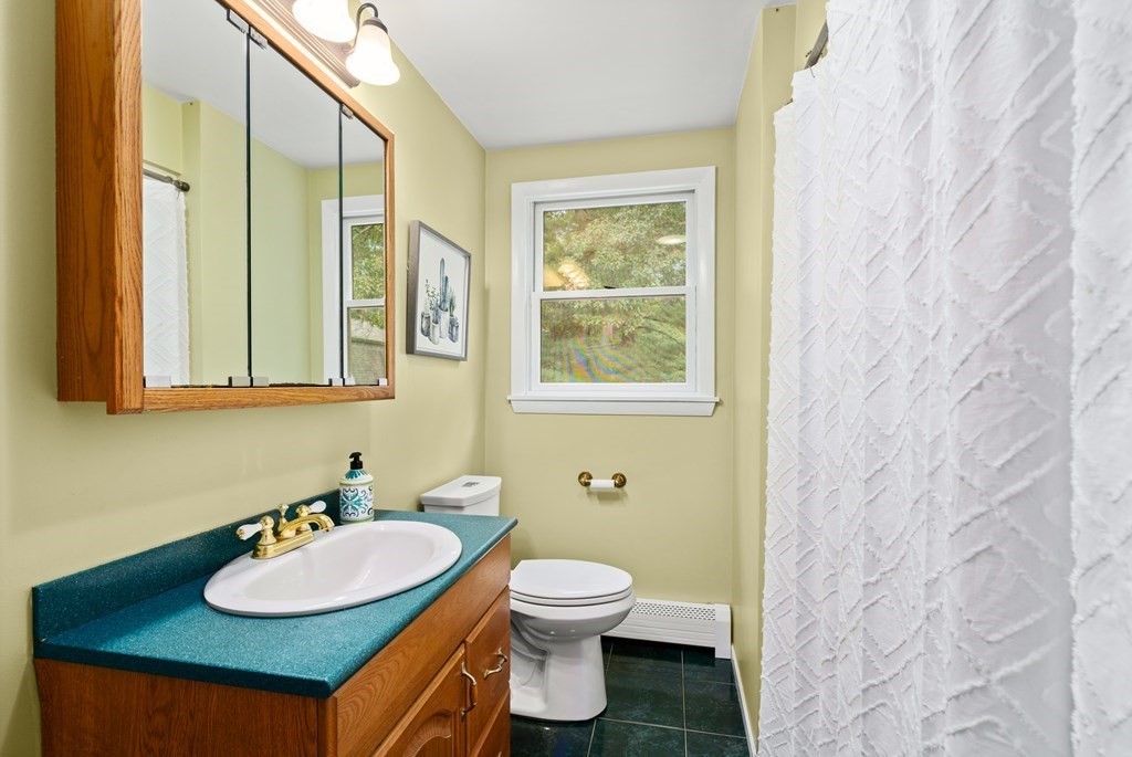 449 Potter Road Framingham, MA 01701 - Photo 17 of 25 a bathroom with a granite countertop sink toilet and a mirror