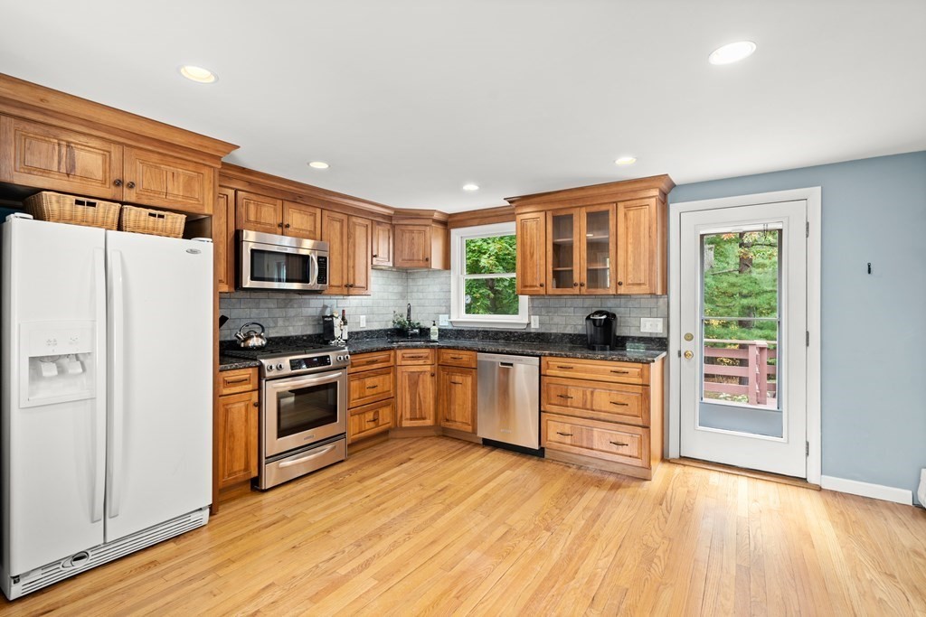 449 Potter Road Framingham, MA 01701 - Photo 3 of 25 a kitchen with stainless steel appliances granite countertop a refrigerator stove top oven and sink