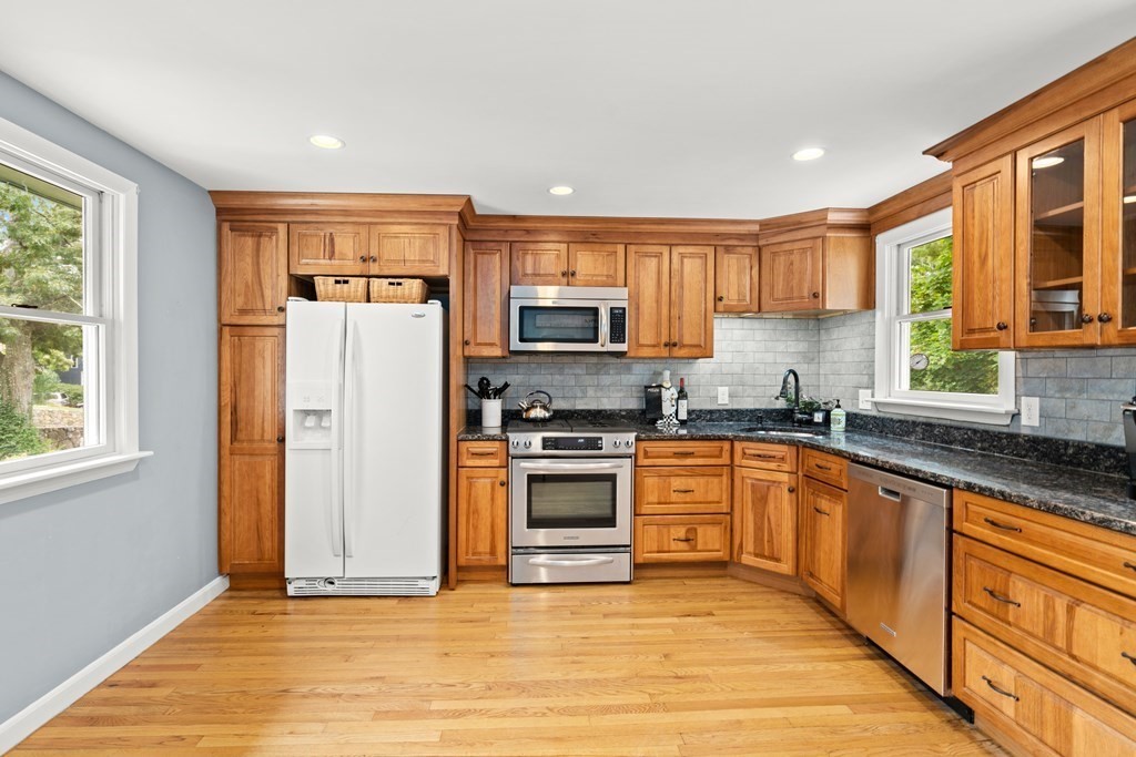 449 Potter Road Framingham, MA 01701 - Photo 4 of 25 a kitchen with stainless steel appliances granite countertop a stove a sink and a refrigerator