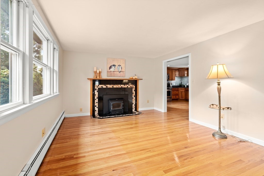 449 Potter Road Framingham, MA 01701 - Photo 5 of 25 a view of empty room with fireplace and wooden floor