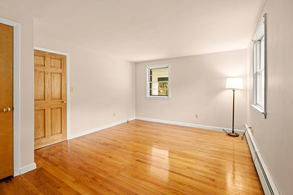 449 Potter Road Framingham, MA 01701 - Photo 6 of 25 a view of an empty room with wooden floor and a window