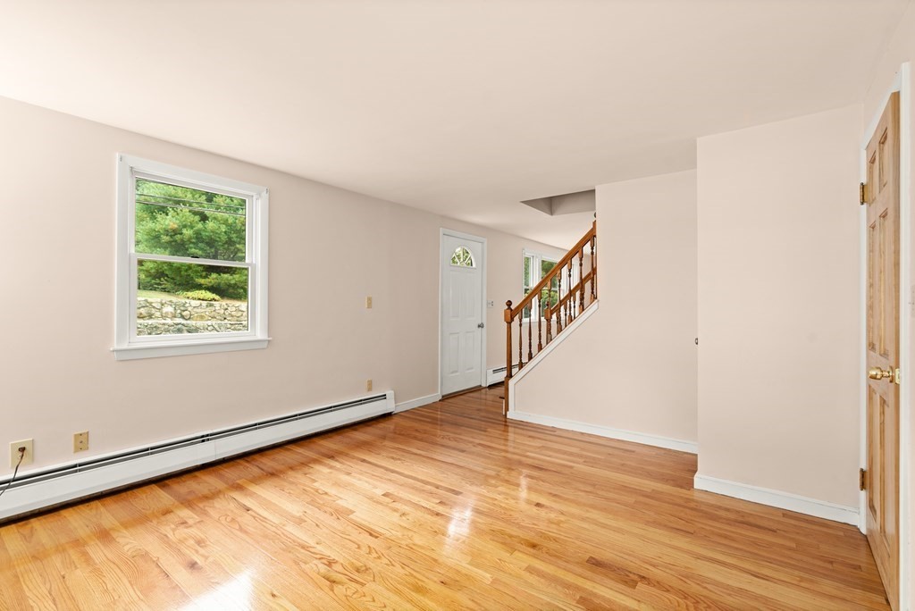 449 Potter Road Framingham, MA 01701 - Photo 7 of 25 a view of an empty room with wooden floor and a window