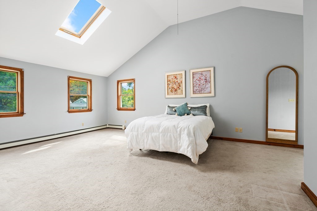 449 Potter Road Framingham, MA 01701 - Photo 8 of 25 a bedroom with a bed and a wall painting