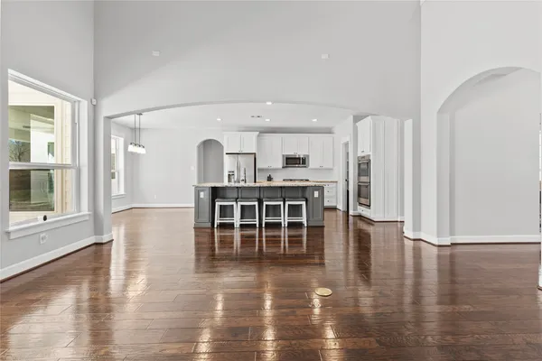 a view of a kitchen with furniture and wooden floor