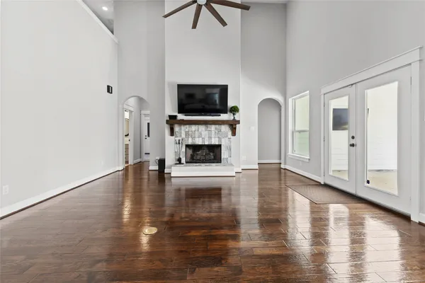 a view of empty room with fireplace and wooden floor