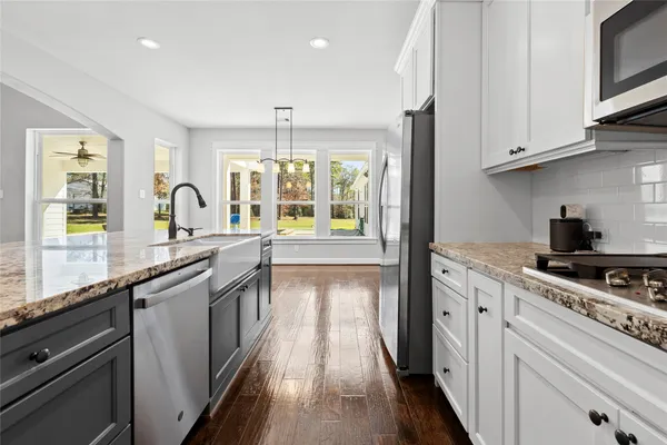 a kitchen with stainless steel appliances granite countertop a stove and a sink