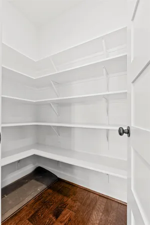 a view of walk in closet with empty racks