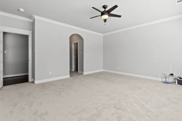 an empty room with a ceiling fan and window
