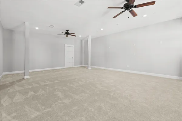 an empty room with a ceiling fan