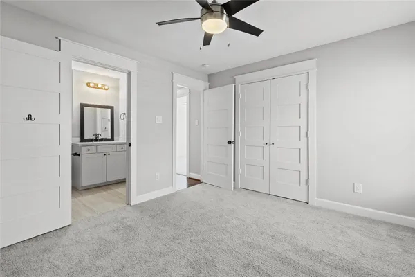 a view of a big room with closet and windows