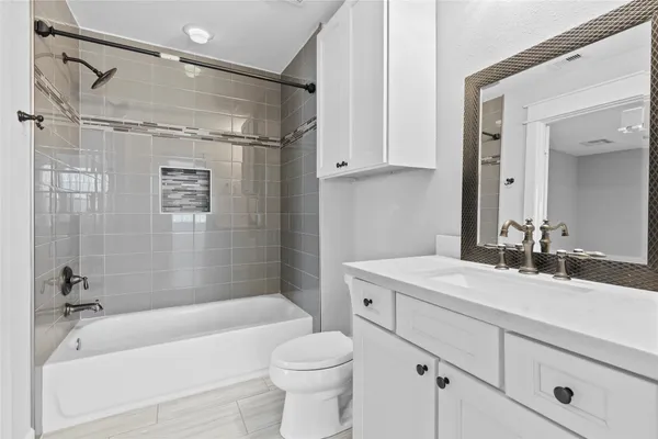 a bathroom with a sink a toilet and a bathtub