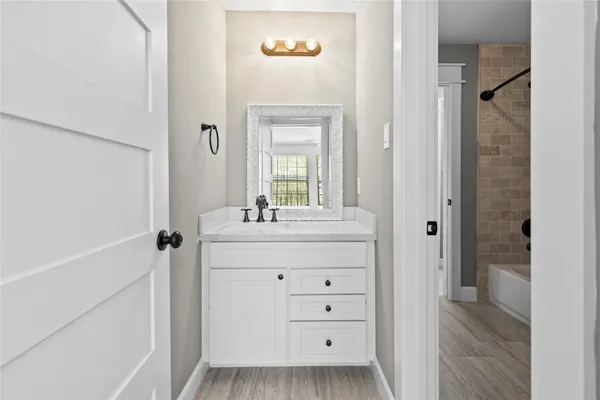 a bathroom with a sink a mirror and a shower