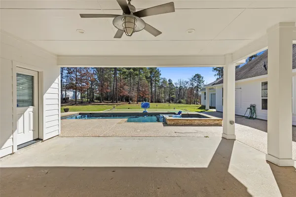 a view of a swimming pool with a yard and a fountain