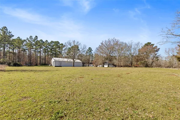 a house view with swimming pool in front of house