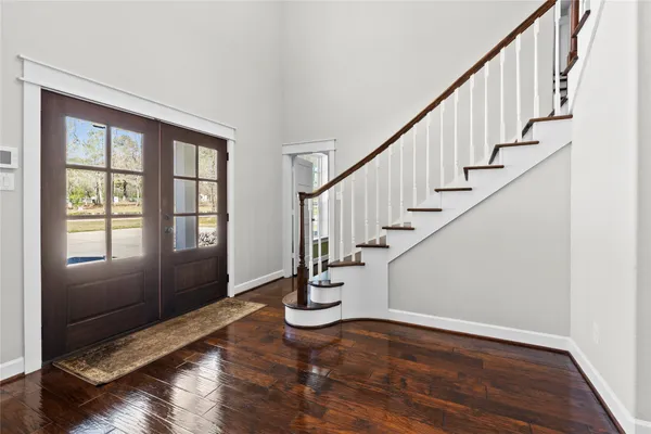 a view of an entryway with wooden floor and stairs