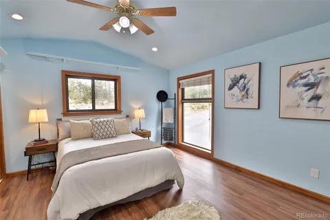a bedroom with a large bed and a chandelier