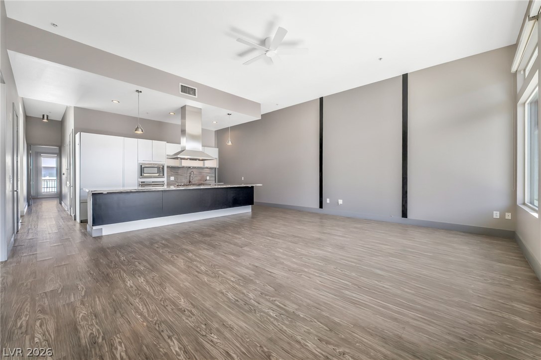 2775 West Pebble Road, Unit 505 Las Vegas, NV 89123 - Photo 4 of 26 An open-concept layout showcases a contemporary kitchen seamlessly flowing into a spacious living area.