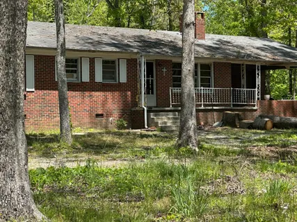 a view of house with backyard