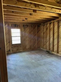 a view of empty room with a fireplace
