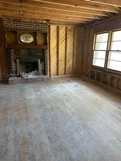 a view of empty room with a fireplace