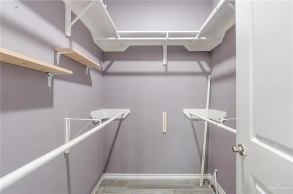 a view of walk in closet with empty racks