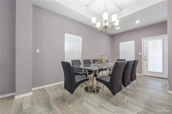 a view of a dining room with furniture and chandelier