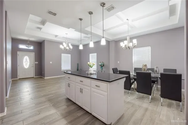 a large kitchen with a lot of counter space and a wooden floor