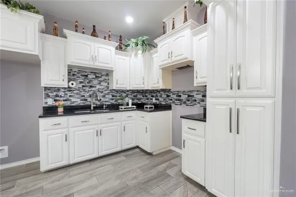 a kitchen with stainless steel appliances white cabinets and a sink
