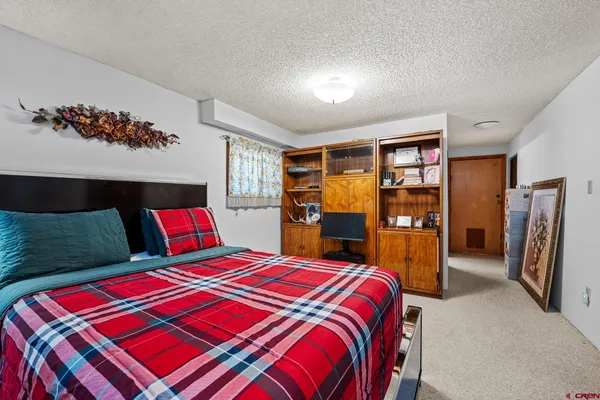 a bed sitting in a bedroom next to a window