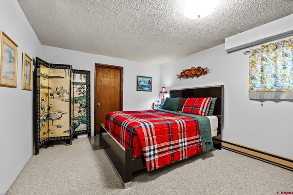 a bed sitting in a bedroom next to a window