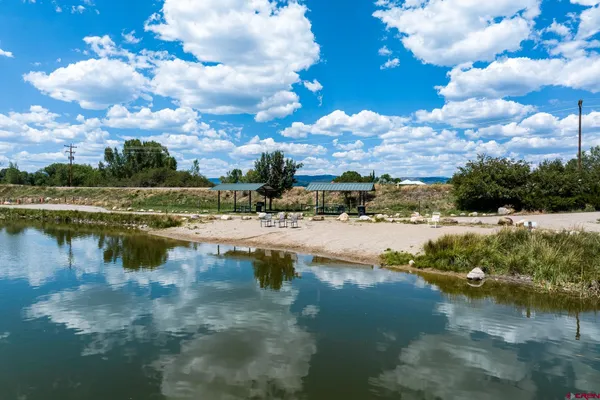 a view of a lake with houses in the back