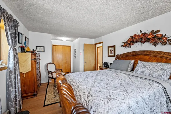 a bedroom with a bed and a table with potted plant